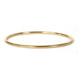 A gold hollow round section bangle,