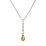 A white gold yellow topaz and diamond pendant,