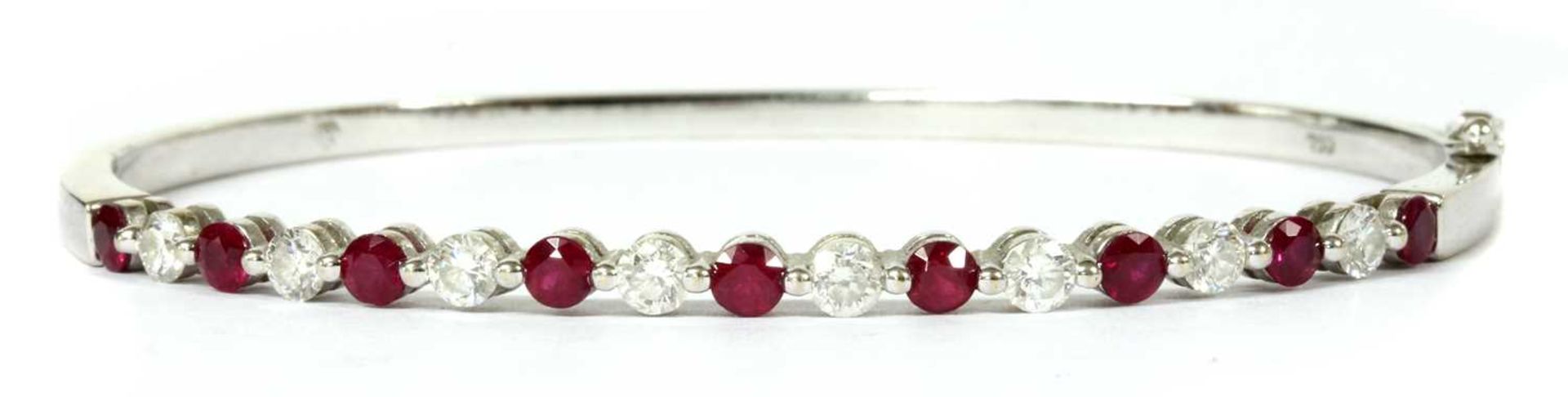 A white gold ruby and diamond hinged bangle,