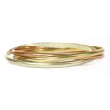A gold Russian wedding ring-style bangle,