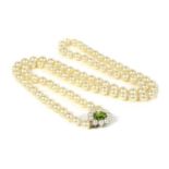 A single row uniform cultured pearl necklace with peridot set clasp,