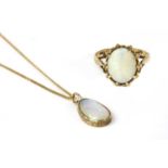 A gold single stone opal pendant,