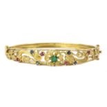 A 9ct gold emerald, ruby and sapphire set hinged bangle, c.1970,