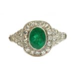 An emerald and diamond cushion-shaped cluster ring,