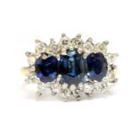 An 18ct gold sapphire and diamond triple cluster ring by E W Adams,