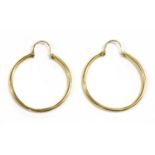 A pair of gold hoop earrings,