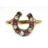 A gold and silver, diamond and ruby, horseshoe ring,