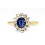 An 18ct gold sapphire and diamond oval cluster ring,