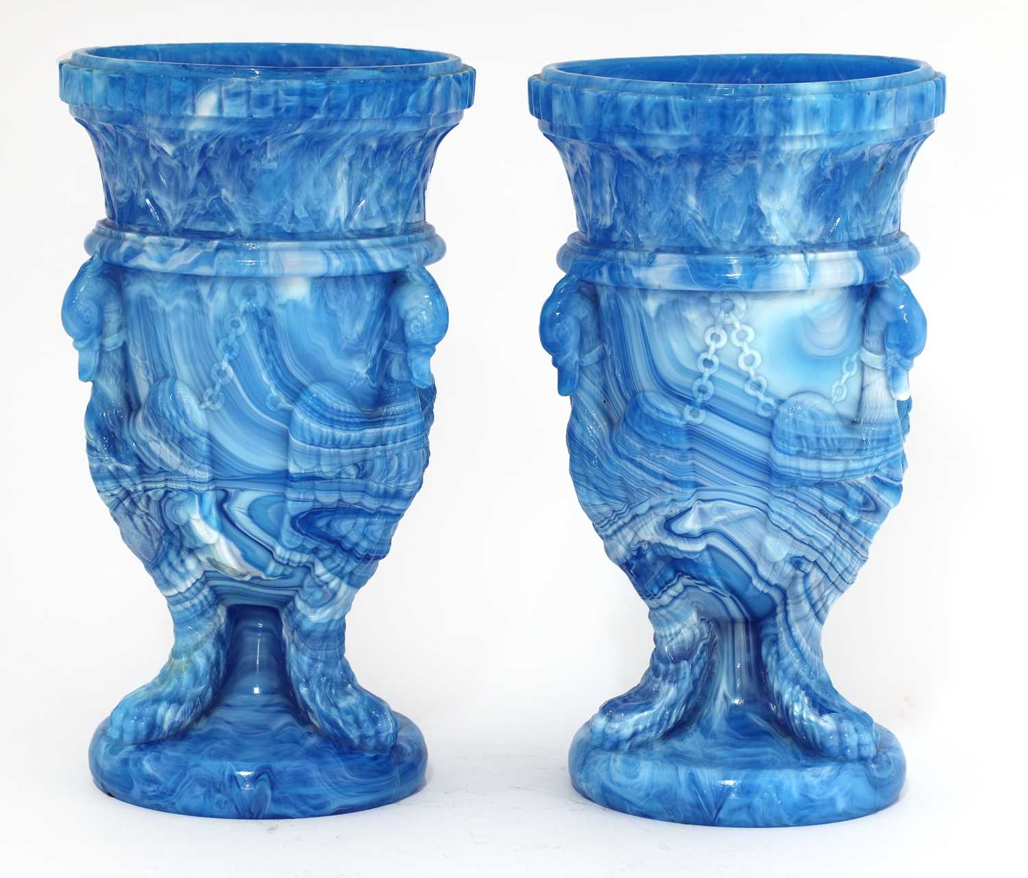 A pair of glass 'gryphon' urns