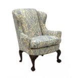 A George II-style wing back armchair,