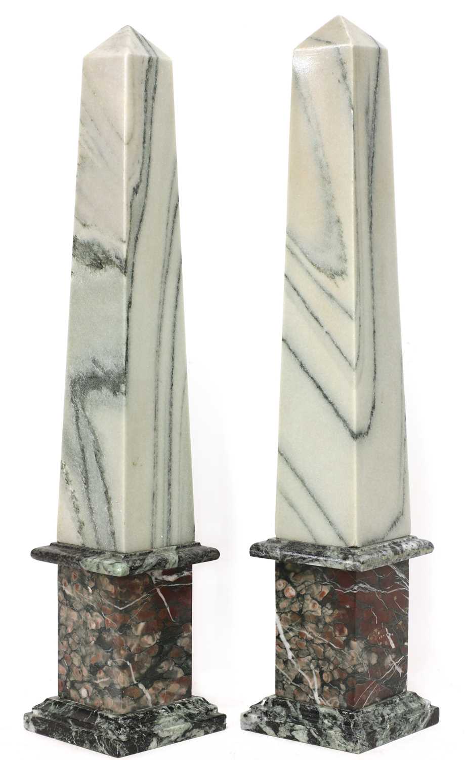 A pair of neoclassical-style marble obelisks,