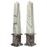 A pair of neoclassical-style marble obelisks,