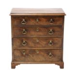 A miniature mahogany chest of four long graduated drawers,