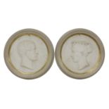 A pair of carved marble roundels,