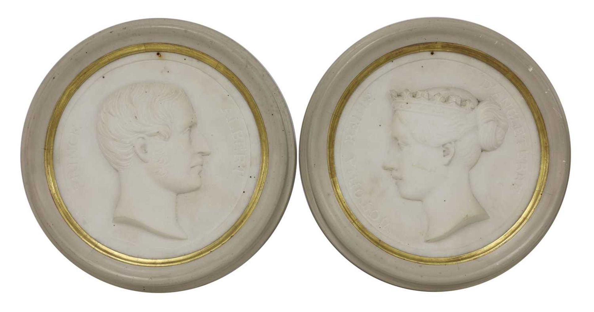 A pair of carved marble roundels,