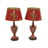 A pair of red toleware-style table lamps and shades,