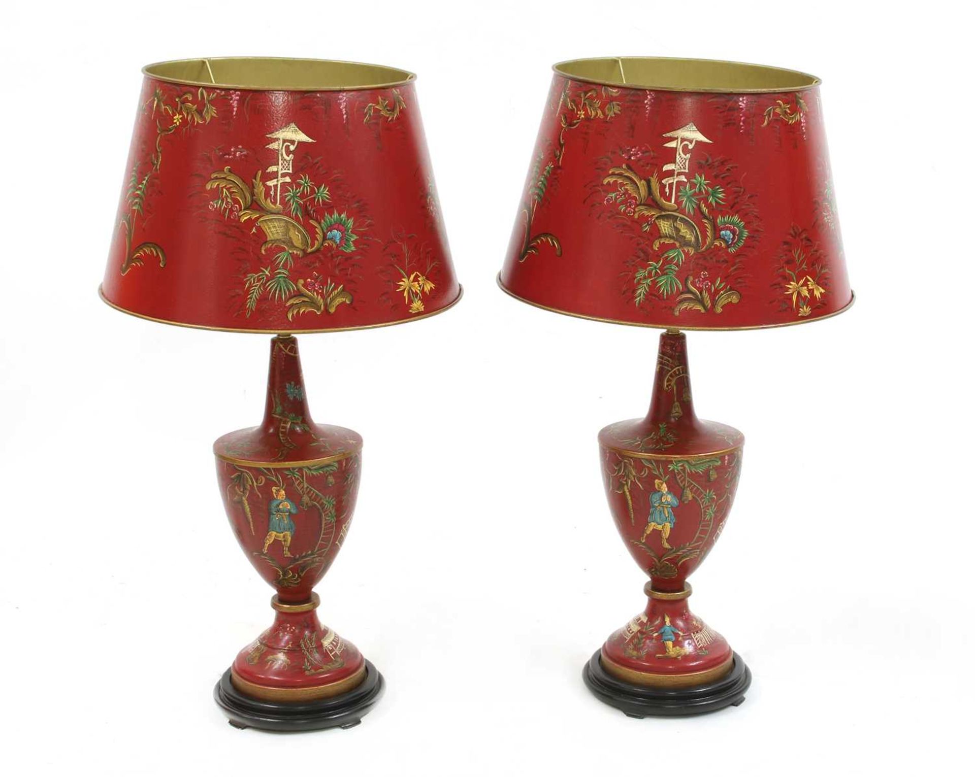 A pair of red toleware-style table lamps and shades,