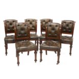 A set of six Victorian walnut and buttoned leather upholstered dining chairs,