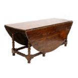 A solid yew wood gateleg table,