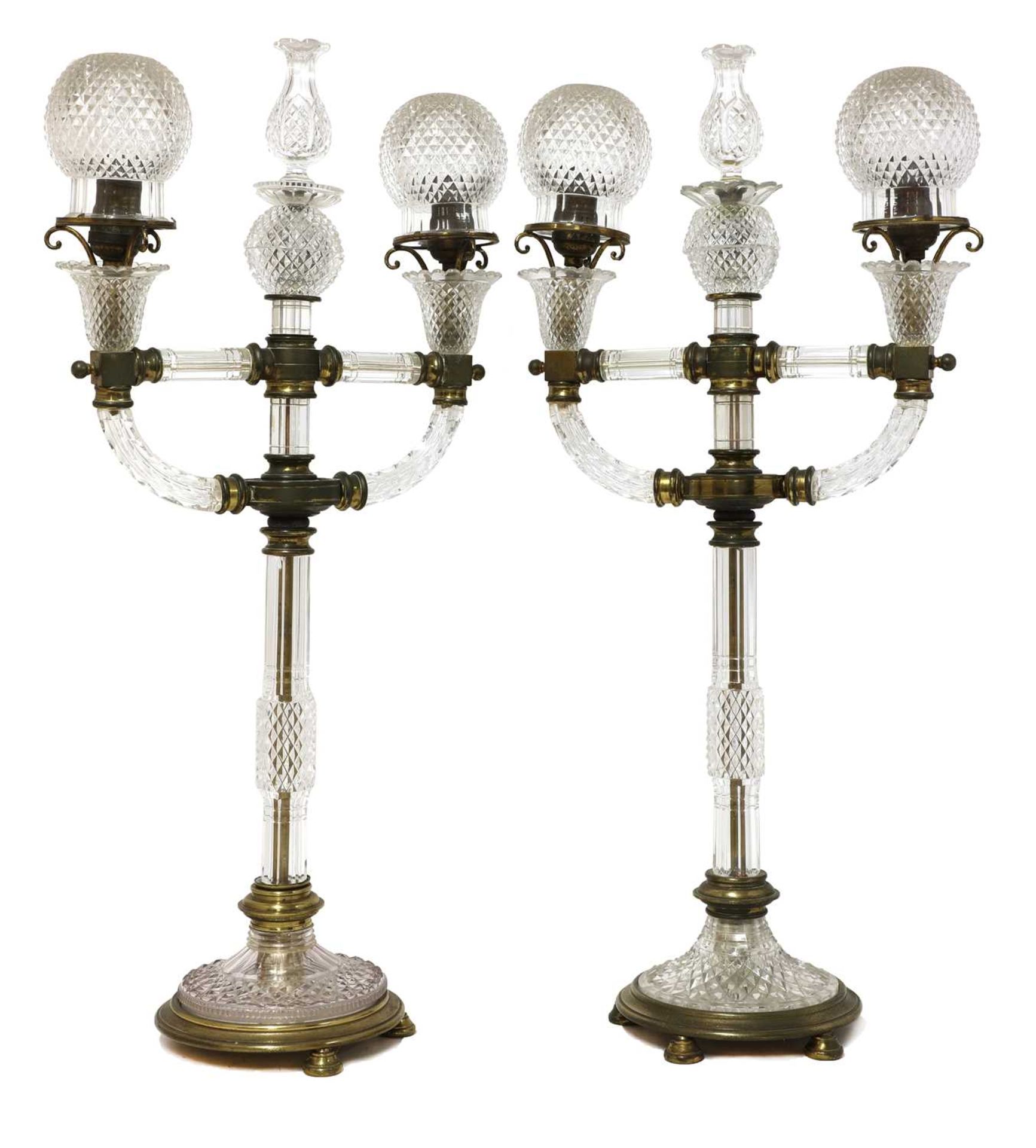 A pair of cut glass and gilt brass electric lamps,