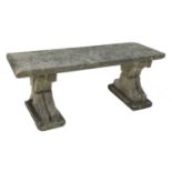 A weathered stone garden bench,