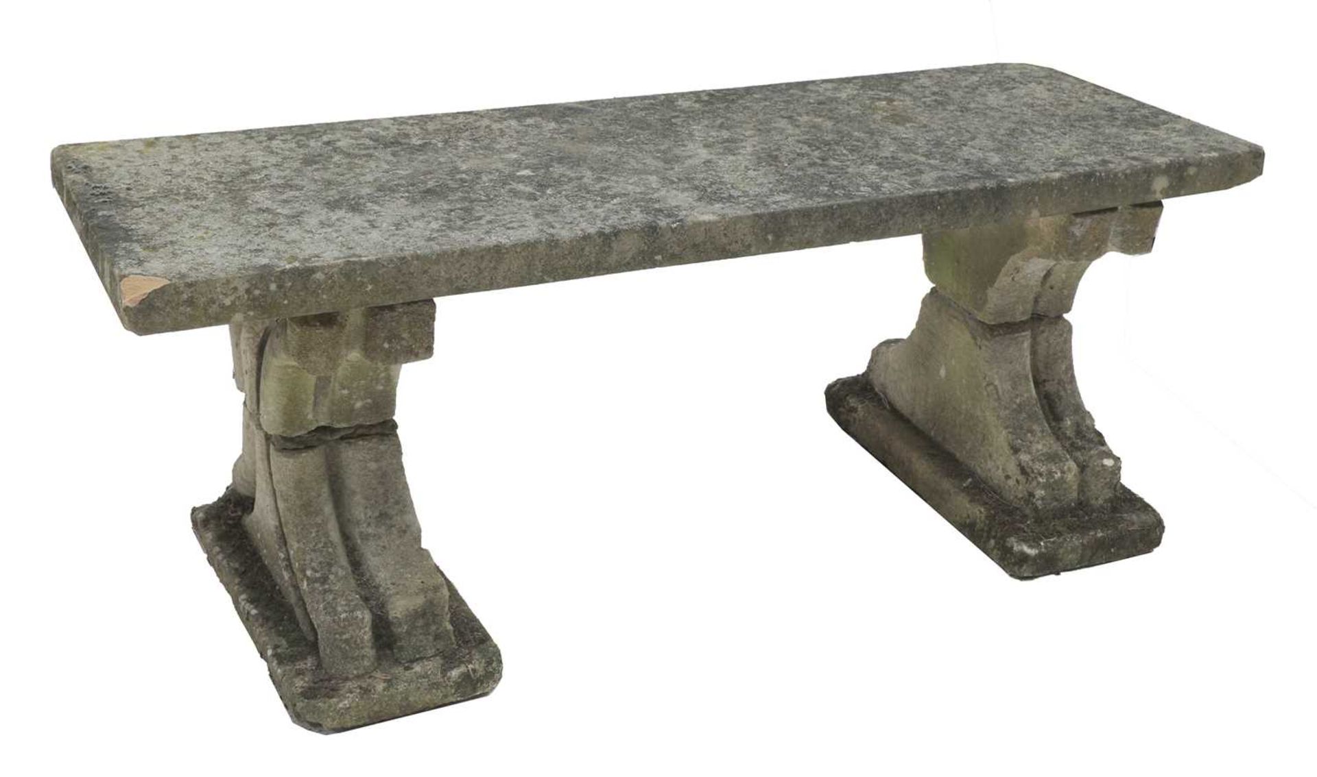 A weathered stone garden bench,