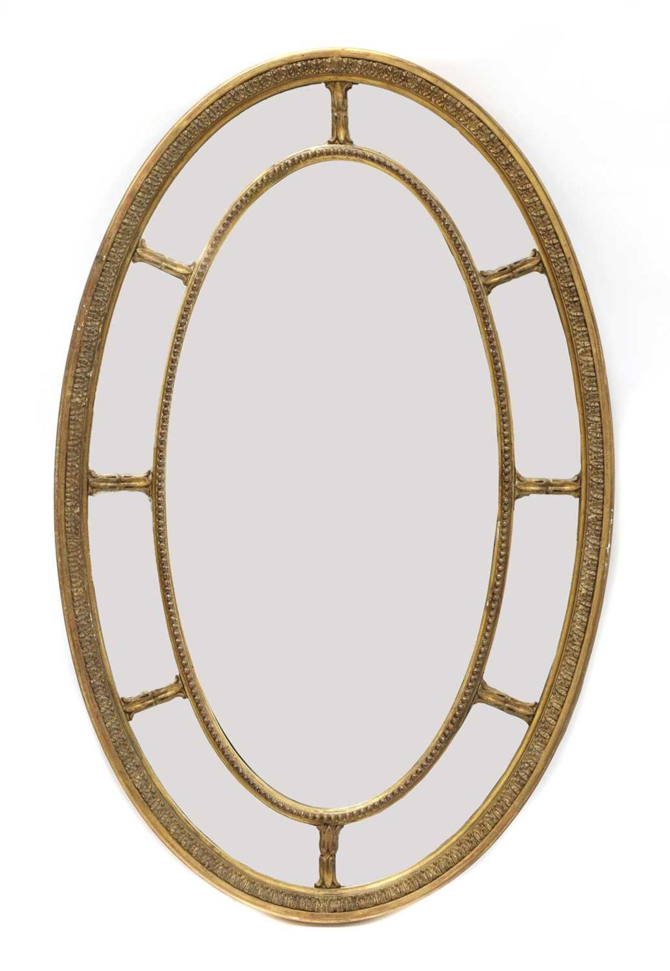 A carved giltwood and gesso oval wall mirror,