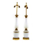 A pair of opaline glass and gilt metal table lamps,