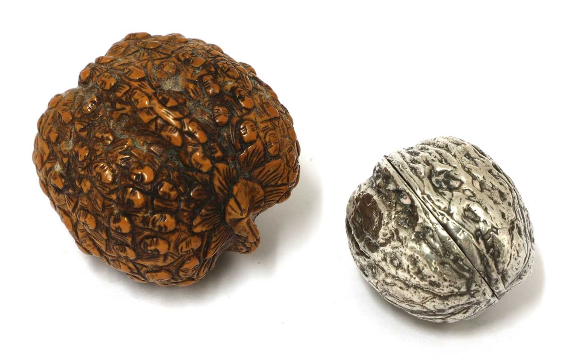 A silver box in the form of a walnut,