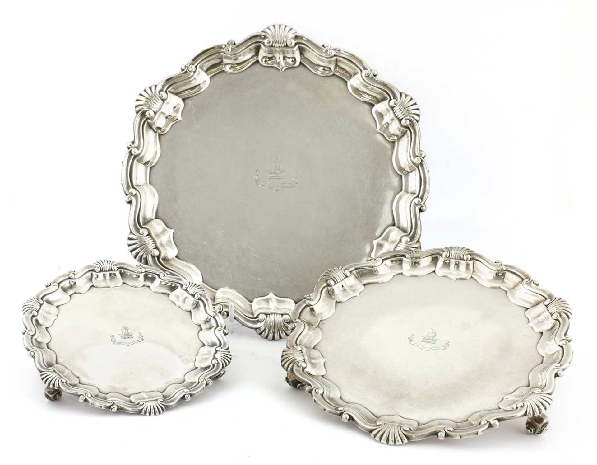 A set of three graduated silver salvers,