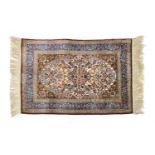 A Turkish silk and metal Hereke rug
