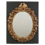 An ornately carved mirror in the style of Grinling Gibbons,