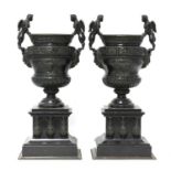 A pair of French bronze and marble garniture urns,