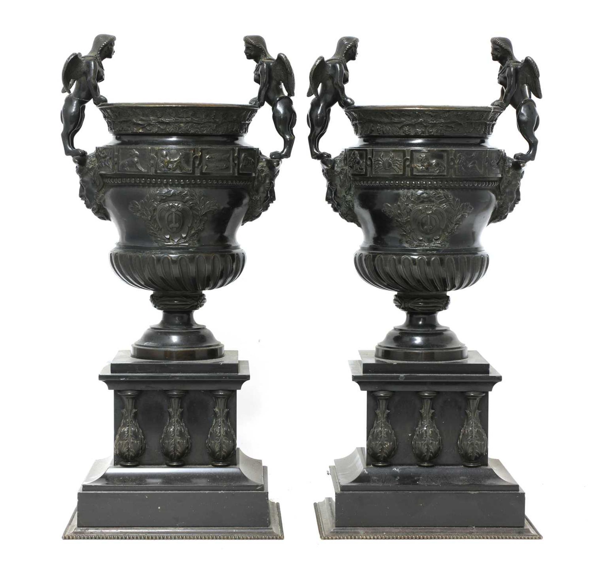 A pair of French bronze and marble garniture urns,