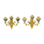 A pair of gilt-bronze three-light wall appliqués,