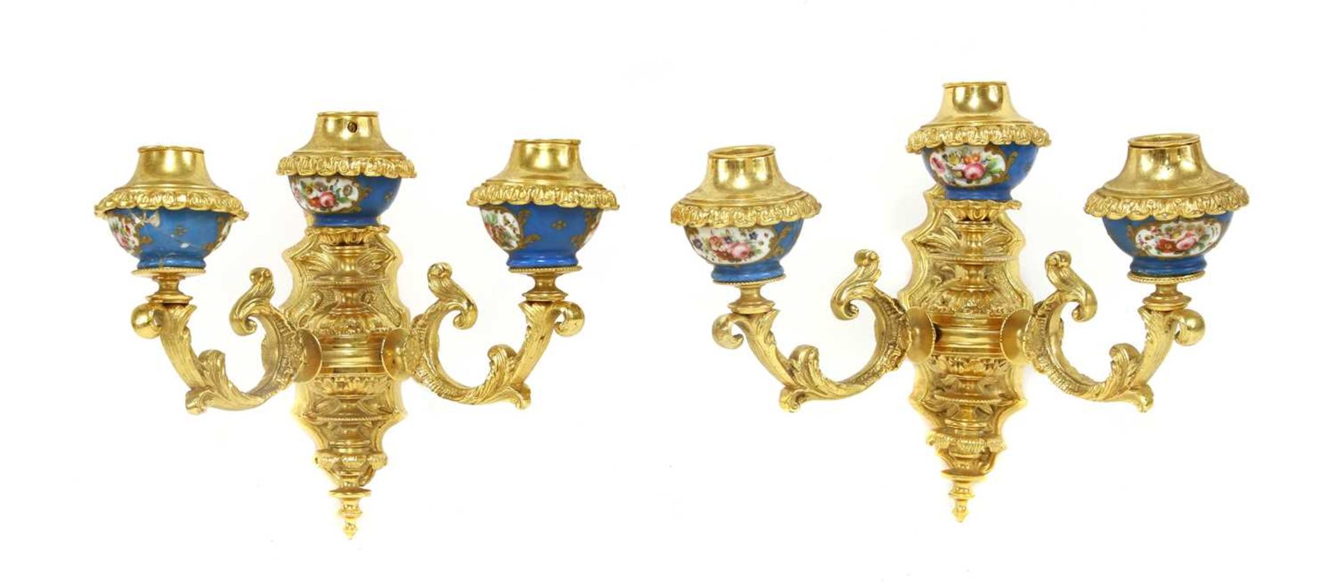 A pair of gilt-bronze three-light wall appliqués,