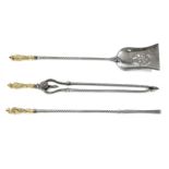 A set of three twisted steel and brass fire tools,