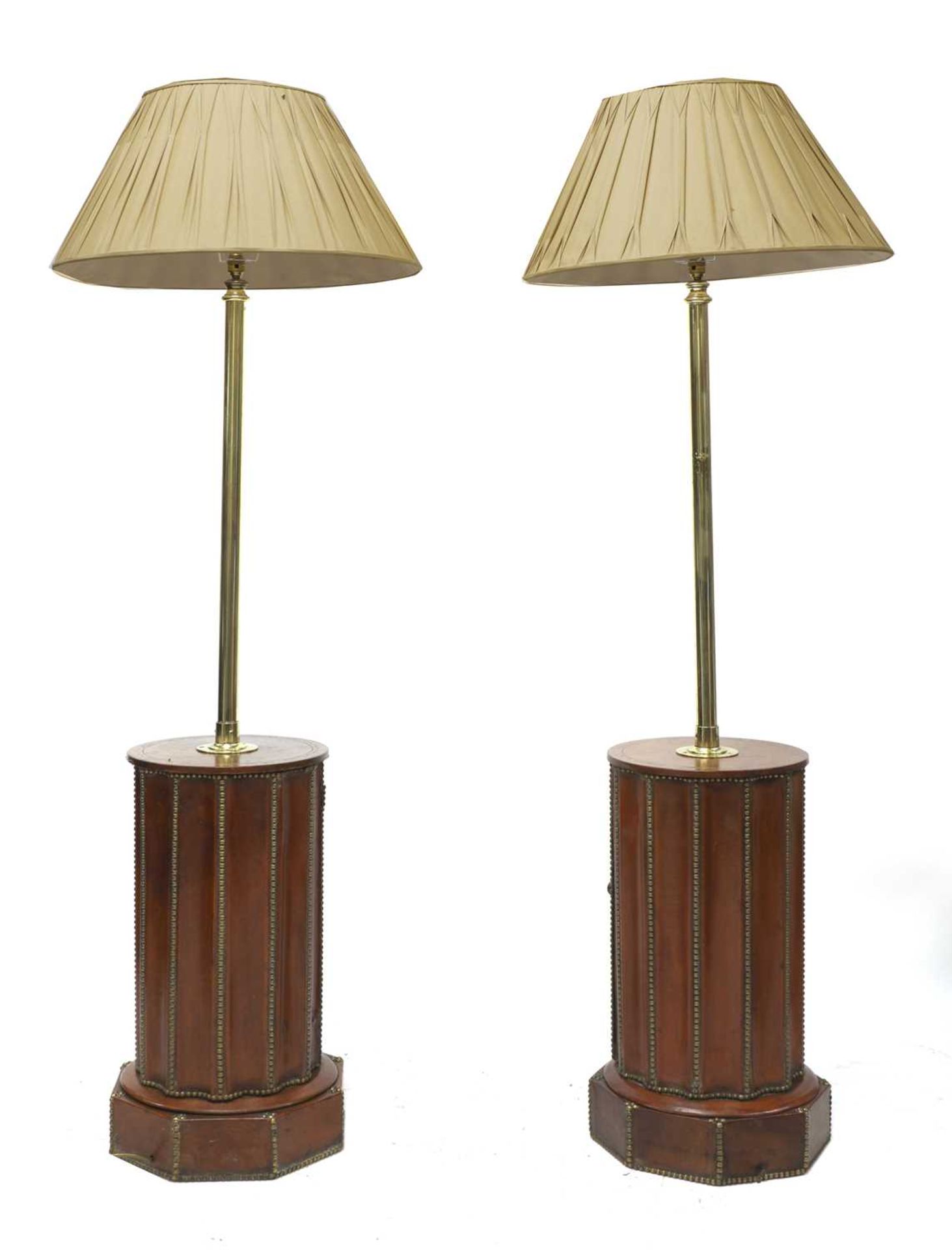 A pair of leather and brass-nailed drum base lamp standards,