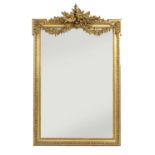 A large gilt-framed wall mirror,