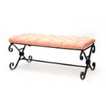 A large wrought iron framed stool,