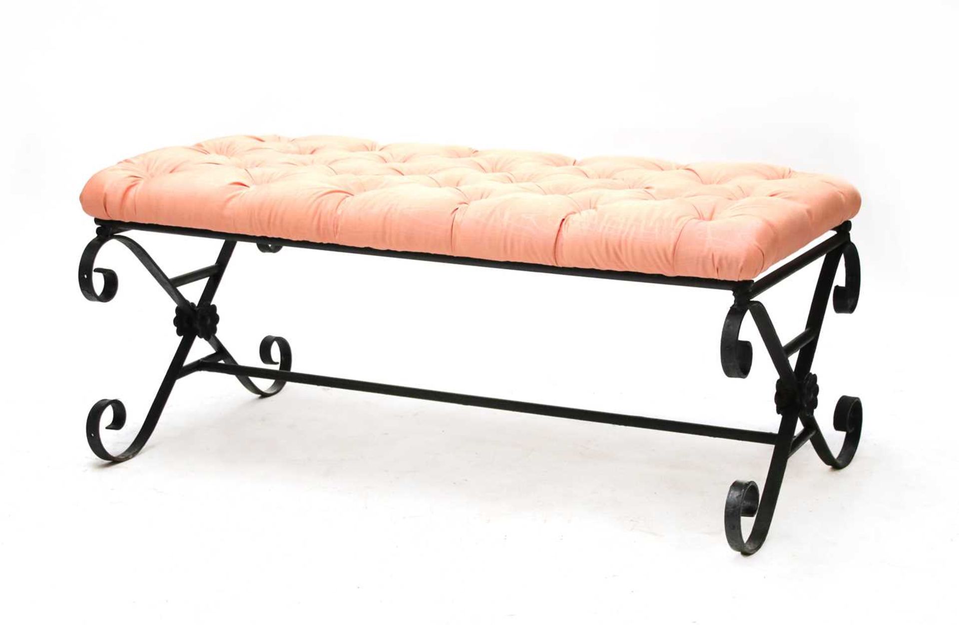 A large wrought iron framed stool,