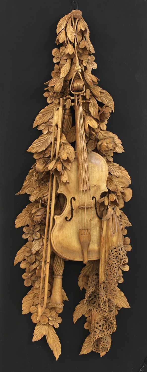 A carved wall hanging in the style of Grinling Gibbons,