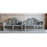 A pair of Lutyens-style weathered teak garden benches,