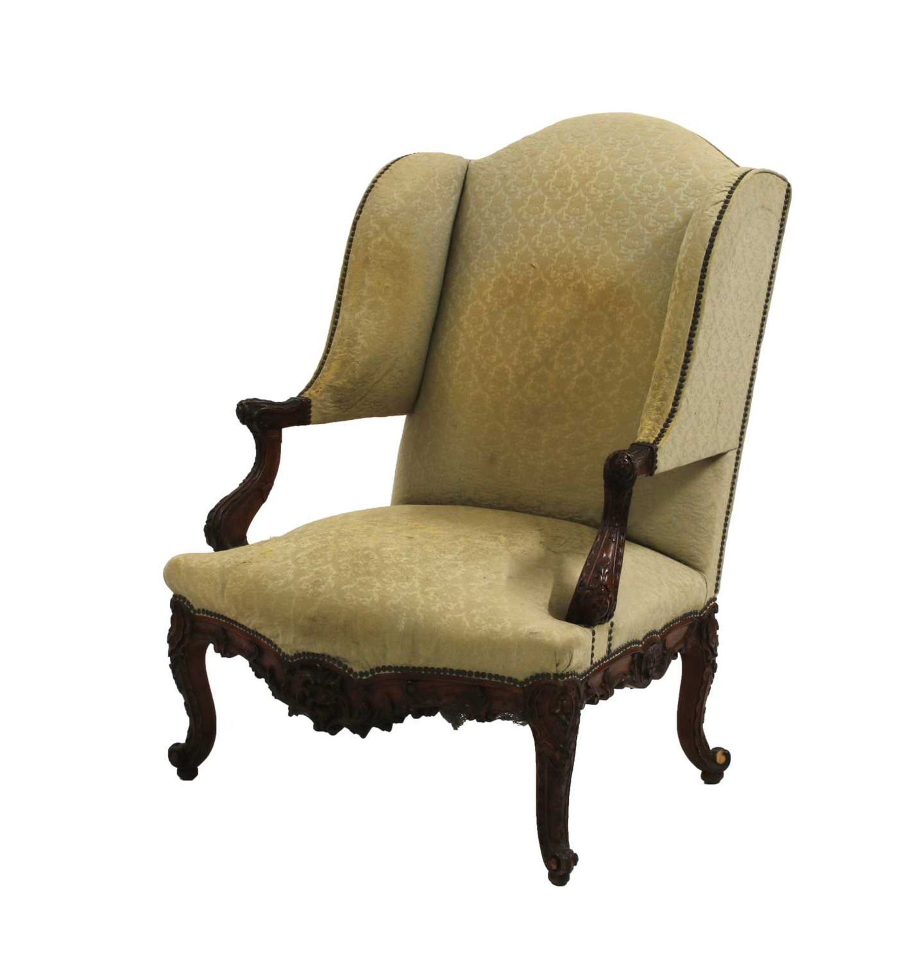 A French Régence walnut wing backed armchair,