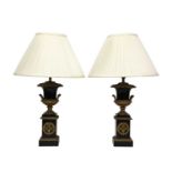 A pair of Napoleon III ebonised and gilt metal urn form table lamps,