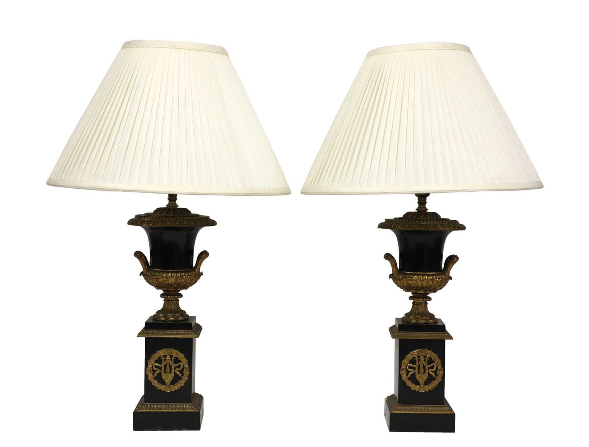 A pair of Napoleon III ebonised and gilt metal urn form table lamps,