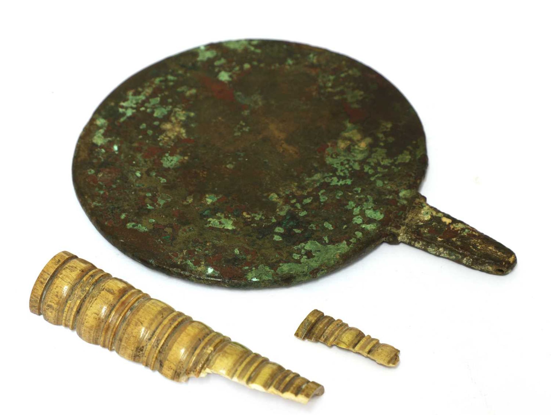 A bronze and ivory mirror,