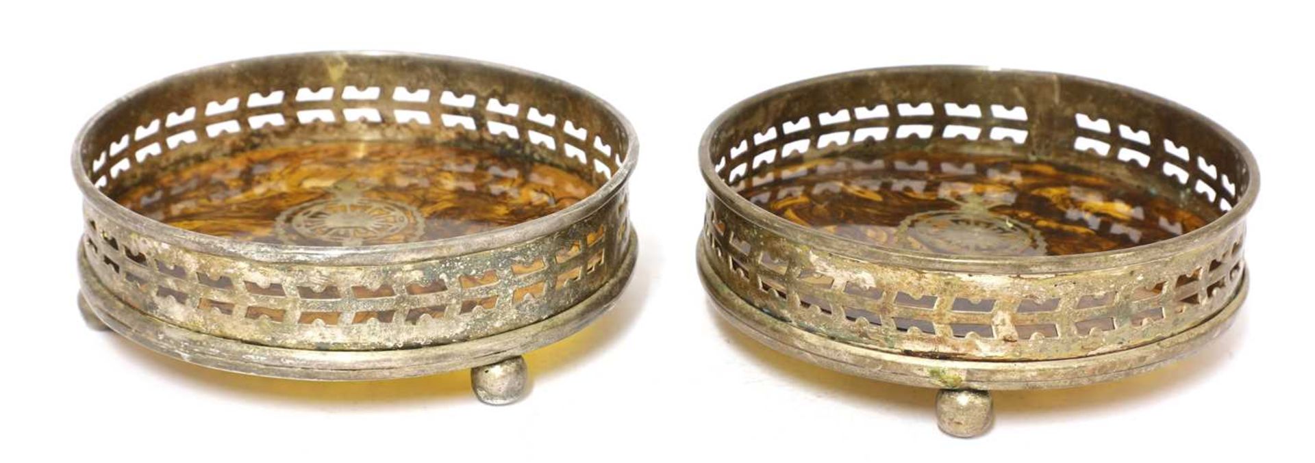A pair of silver-plated coasters