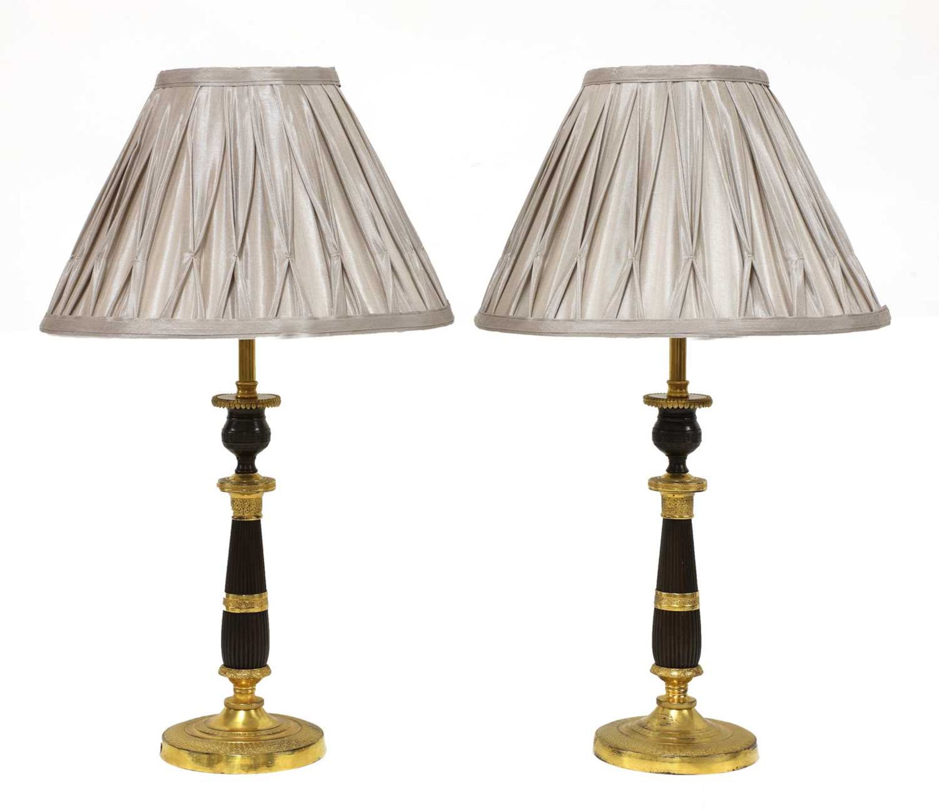 A pair of French Empire-style bronze and gilt-bronze candlesticks,