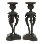 A pair of bronze candlesticks,